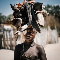 Himba boy collecting wood Epupa Falls Namibia