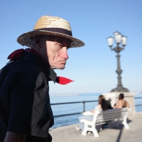 the man with the straw hat and the red scarf